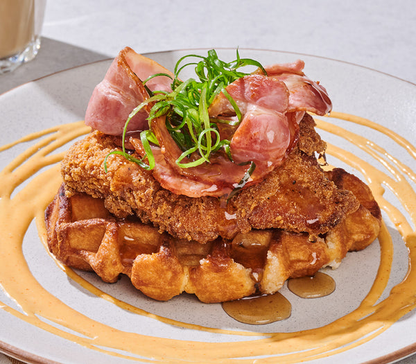 <p>A Belgian waffle stacked with crispy chicken & grilled bacon.<br/>Served with maple syrup & sriracha aioli.<br/>5290kJ</p>